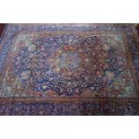 A large 20th century Kashan carpet, the central floral medallion surrounded by floral motifs, on a