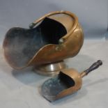 A vintage copper coal scuttle with handle and scoop.