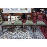 A set of four Regency brass inlaid carved dining chairs, having scrolling foliate carved top rail