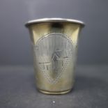 A Russian silver vodka cup, engraved with vignettes of houses and flowers, hallmarked, H.4.3cm,