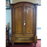 A Continental 19th century armoire, with arched moulded cornice above twin barley twist pilasters,