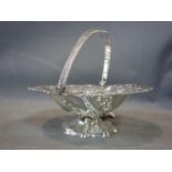 A 19th century silver swing handled fruit basket of pierced circular form decorated with grape vines