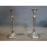 A pair of George III filled silver candlesticks by Richard Carter, Daniel Smith & Robert Sharp