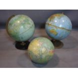 Three vintage globes, two on circular stands, one missing stand