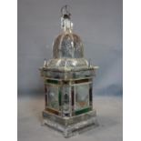 A Middle Eastern metal storm lantern, with glass panels and pierced floral design, H.72cm