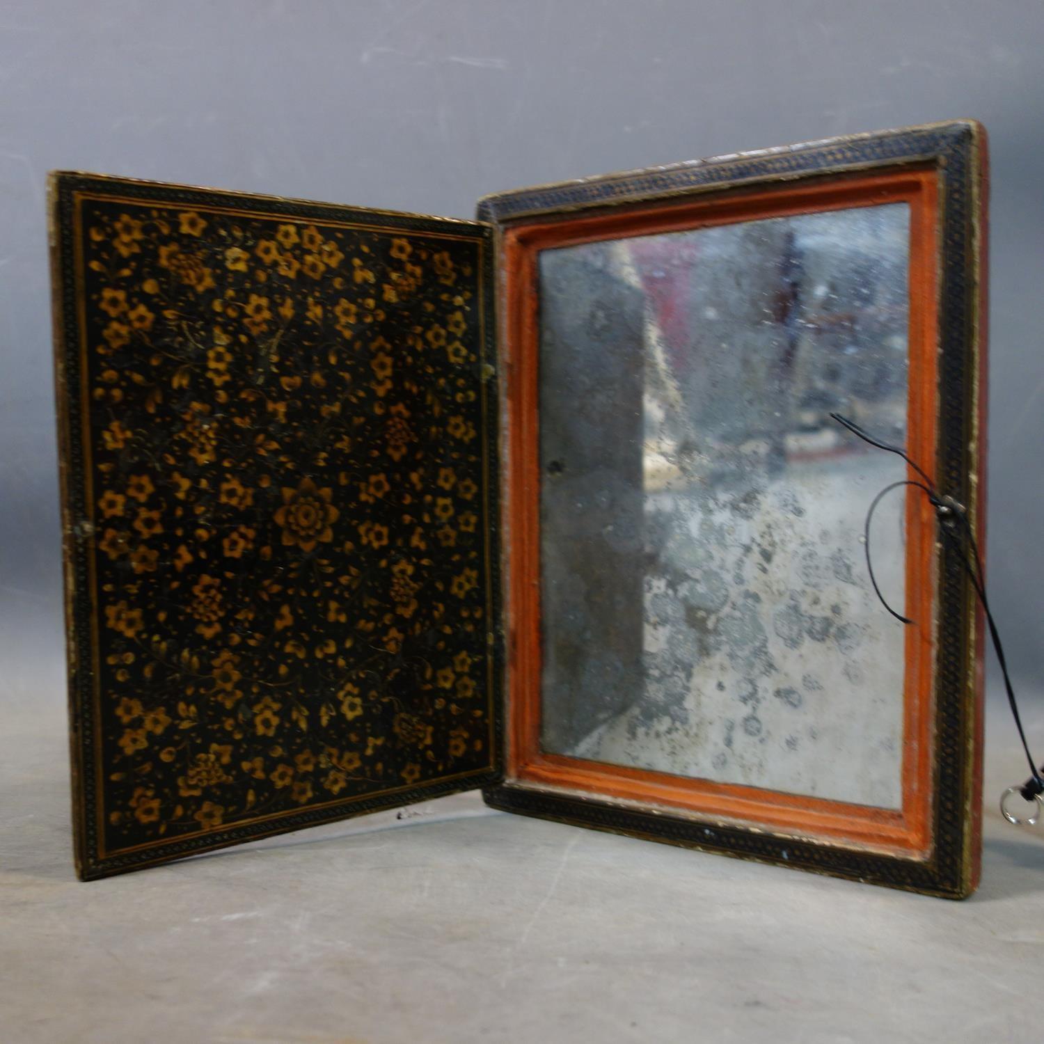 A hand painted Persian mirror case, papier-mâché, gilded lacquered with original mirror inside, 18th