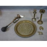A collection of brass items including two candlesticks, a brass trumpet, and a decorative middle
