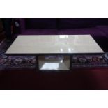 A cream marble rectangular low table on square base. H.46 L.125 D.70cm