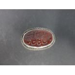 A late 19th / early 20th century Middle Eastern silver pill box, with carved carnelian to top with