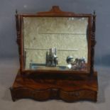 A Georgian mahogany serpentine fronted toilet mirror, the later glass plate on turned supports