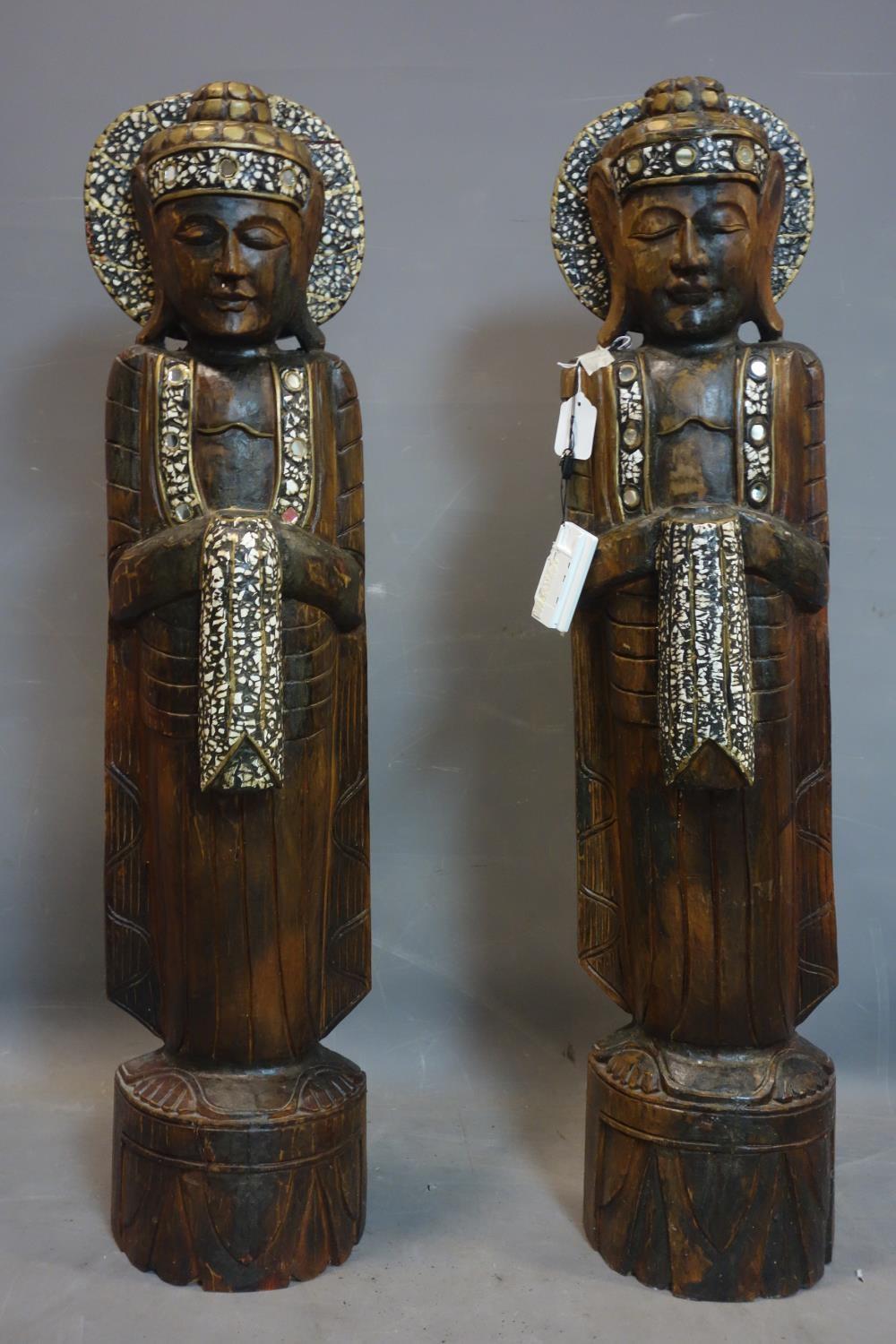 A pair of Thai carved wooden standing Buddhas, H.105cm