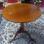 A 19th century circular mahogany tilt top occasional table, on turned support and three outswept