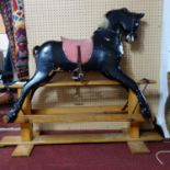 A vintage rocking horse, with reins, saddle and horsehair, H.93 W.110 D.45cm (horse), in need of