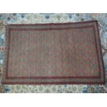 An antique Persian rug, 196 x 124cm