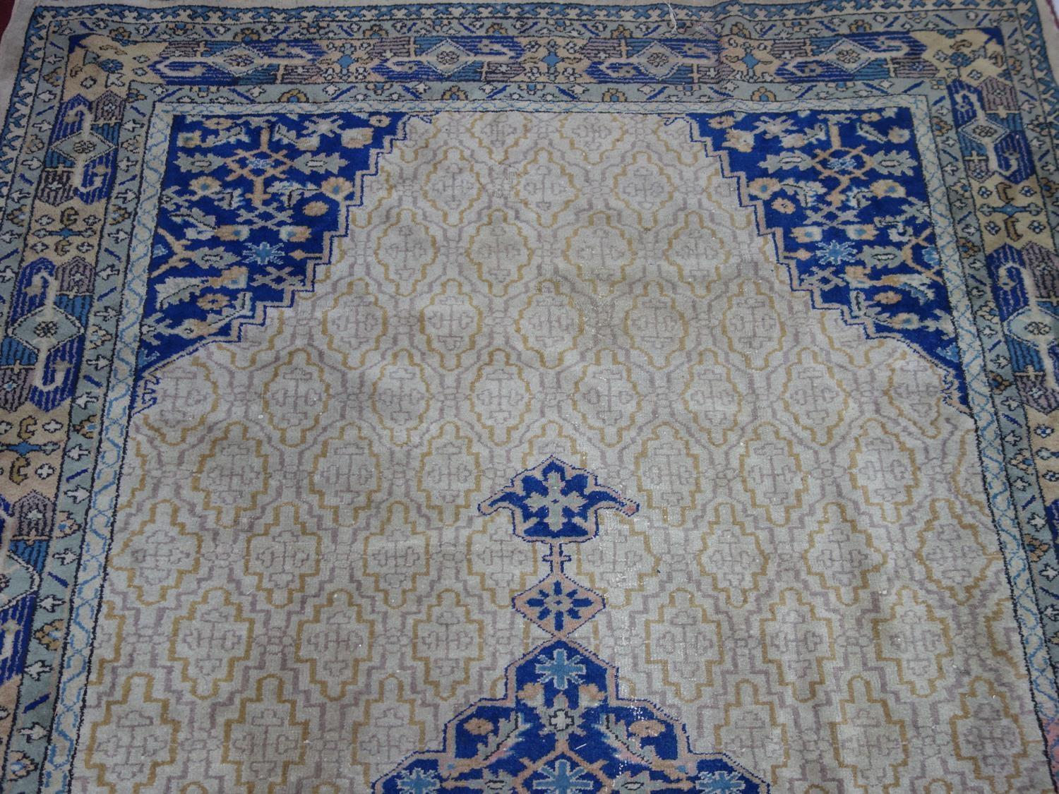 A Turkish carpet with central medallion on a tan ground with repeating stylised floral motifs, - Image 3 of 5