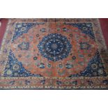 An early 20th century north east Persian Meshad carpet, the central blue floral medallion, on a