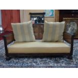 An Edwardian mahogany bergere sofa