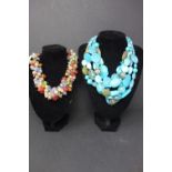 Two turquoise plastic and colorful glass beads