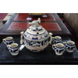 A German stoneware punch bowl and cover, with pheasant to finial and having oak leaf and animal