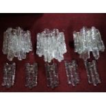 A set of three 1960's Kalmar ice glass wall lights, with spare glass