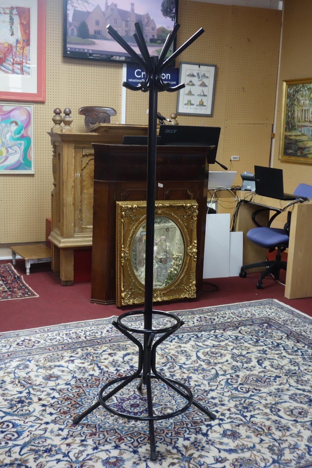 A contemporary black metal coat and hat stand, H.180cm