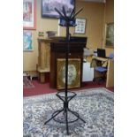 A contemporary black metal coat and hat stand, H.180cm