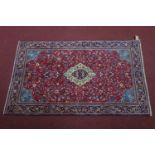 A Central Persian Sarouk rug, central double pendant medallion with repeating petal motifs on a