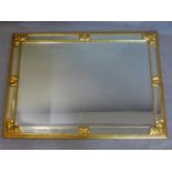 A rectangular gilt mirror with bevelled glass plate and mirrored bevelled glass border and gilt