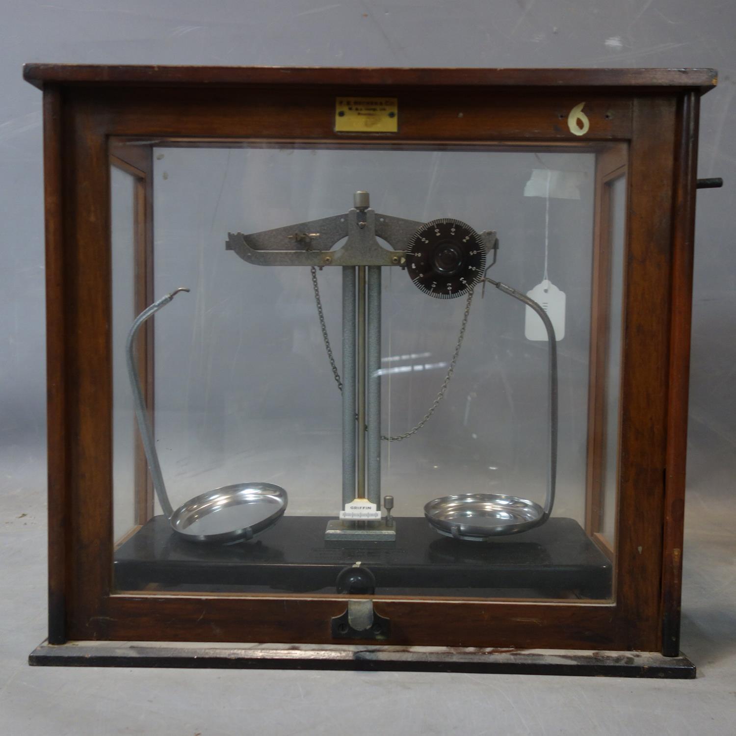 A set of vintage weighing scales by Griffin & George, with Bakelite base, set in glass case by F.E