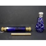 A blue cut glass scent bottle with silver top, H.9.5cm, together with a blue glass and brass