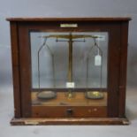 A set of vintage weighing scales set in glass case by W & J George LTD, H.42 W.47 D.30cm