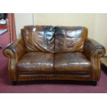 A Howard style stud bound leather sofa