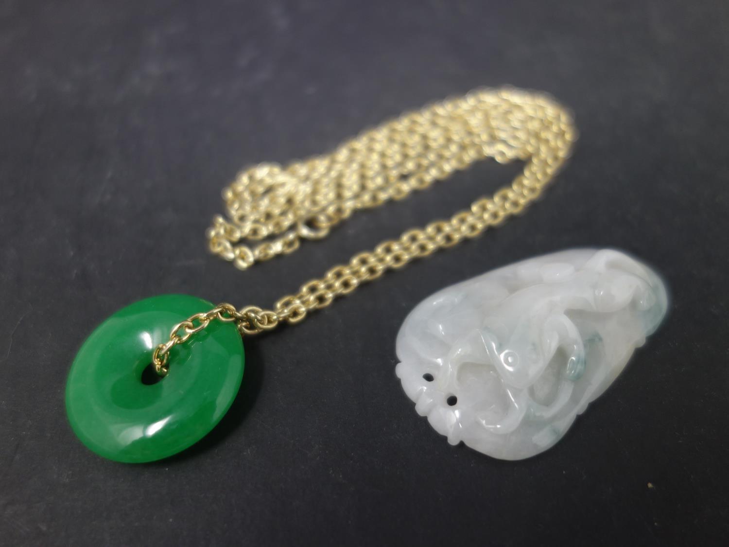 A Chinese jade pendant together with a Chinese carved jadeite pendant