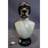 A moulded bust of a dog dressed as a racing driver, raised on socle base, H.52cm