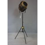 A contemporary adjustable theatre lamp, battery operated, on tripod stand, H.135cm