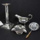 A mixed collection of silver, to include a filled silver candlestick, stamped Sterling, H.19.5cm;