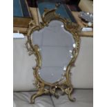 A Rococo style heavy brass mirror with bevelled glass plate, cracked, 61 x 37cm