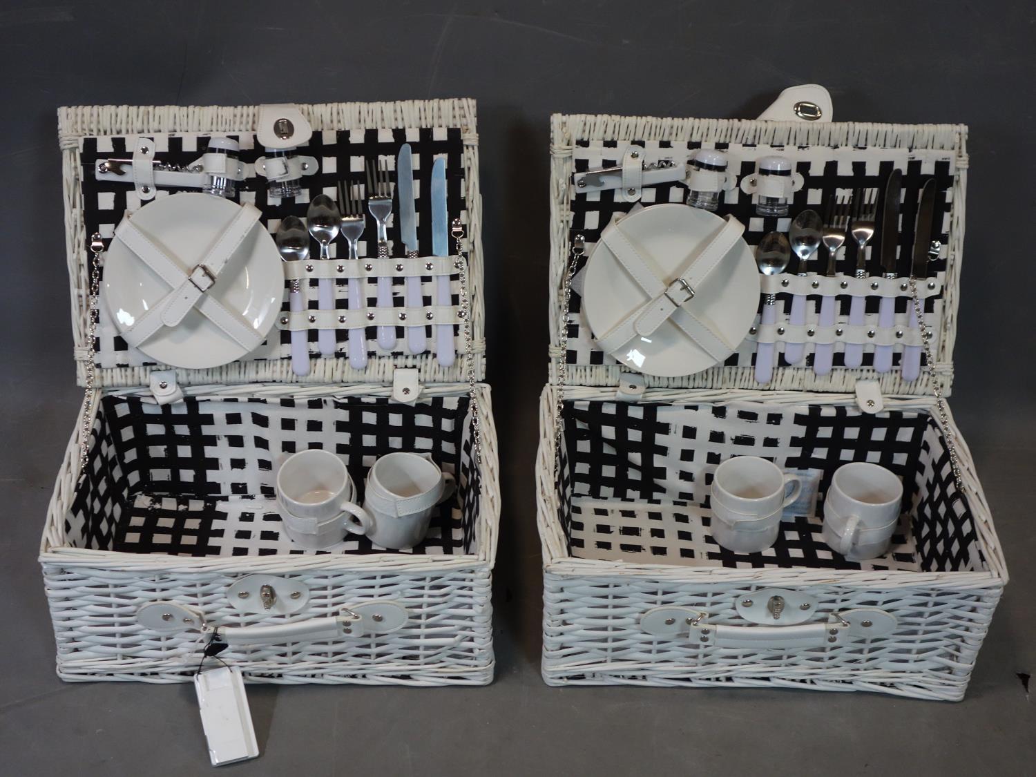 Two wicker picnic baskets, each having 2 cups, 2 side plates, 2 knives, 2 forks, 2 spoons, corkscrew