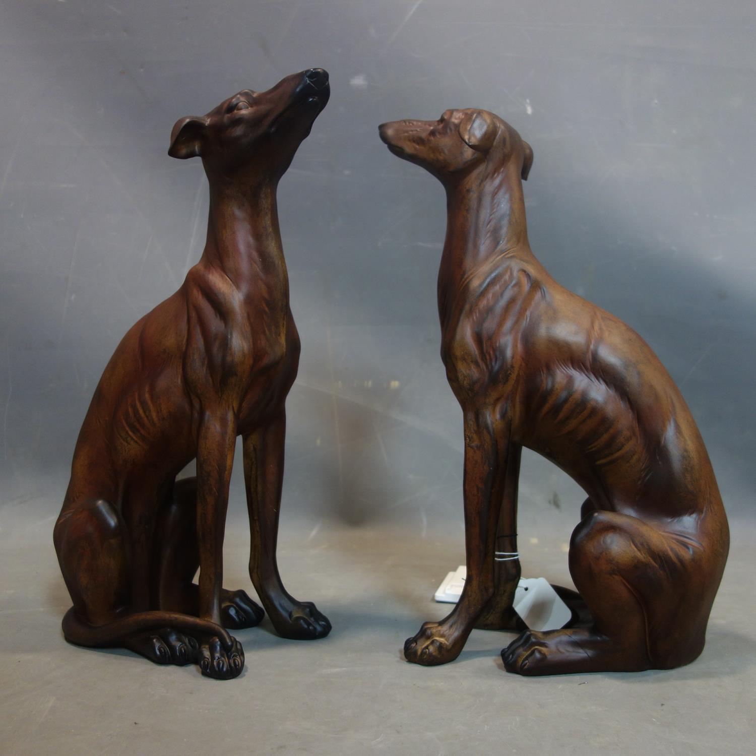 A pair of moulded figures of seated sighthounds, H.45cm (2)