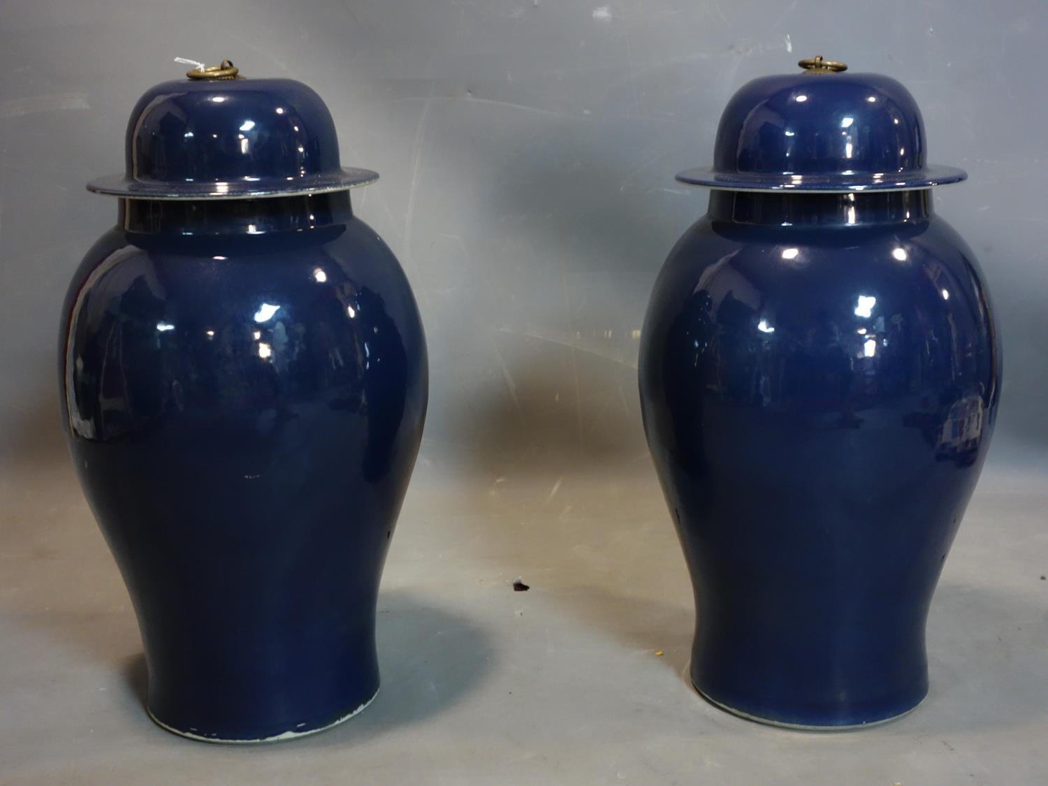 A pair of Chinese blue glazed temple jars and covers, H.53cm