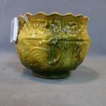 A Victorian green glazed jardiniere with floral design, signed to base, H.25 D.30cm