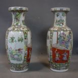 A pair of large Chinese vases, decorated with noblemen watching a fighting display and borders of