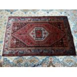 A North West Persian Zanjan rug, central diamond medallion with repeating petal motifs on a