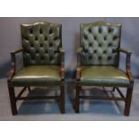 A pair of Georgian style mahogany Gainsborough armchairs, with green button back leather upholstery