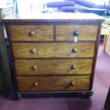 A Victorian mahogany chest of two short over three long drawers, raised on turned legs, H.117 W.