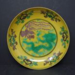 A yellow ground dish representing a Dragon and a Phoenix together with a collection of small