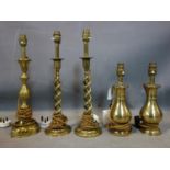 Four decorative brass lamps, to include a pair with twisted stems, H.42cm, a pair of baluster shaped