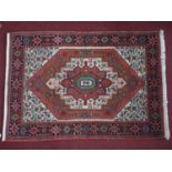 A Persian Shiraz rug, central floral medallion on a cream ground and having floral spandrels, within