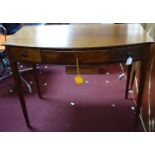 A 19th century mahogany bowfronted desk, with one long and two short drawers, on square tapered