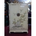 A Chinese cream lacquered cabinet, decorated with birds and flowers, with two cupboard doors above
